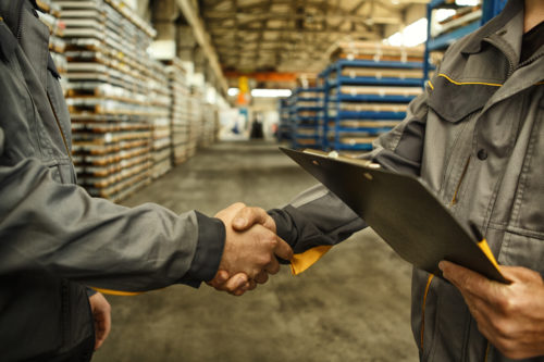 Engineer shaking hands at the industrial factory